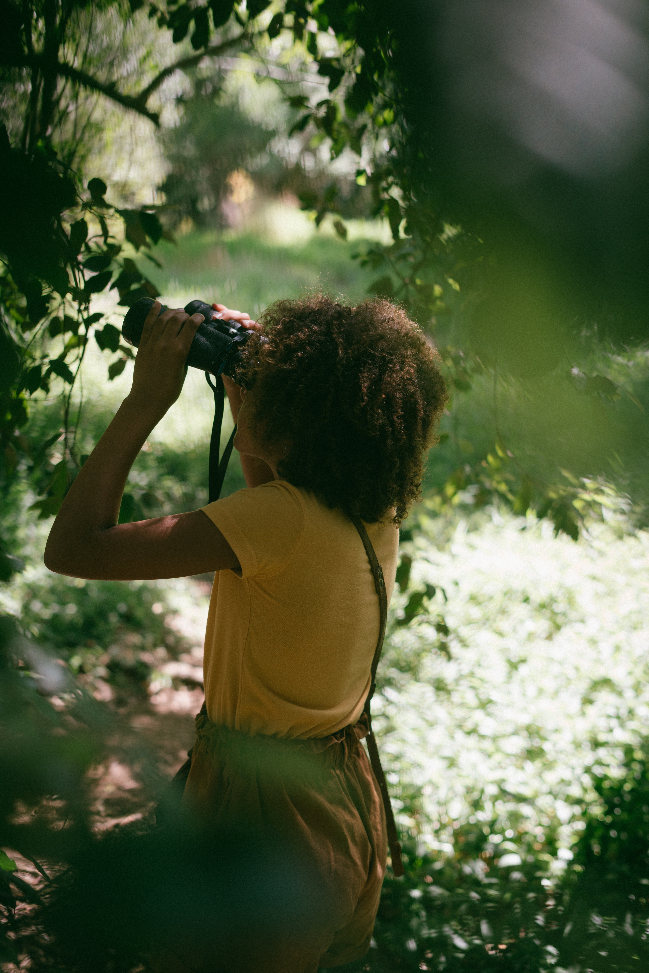 Kid with Binoculars in the Forest